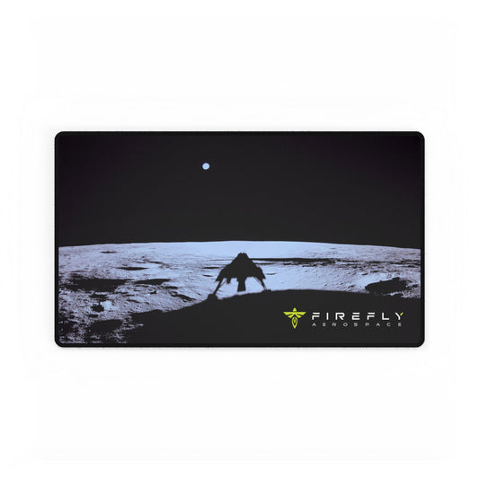 A rectangular gaming mouse pad with rounded corners featuring a black and white sci-fi landscape graphic of a rover and an astronaut under a dark sky, with the 'FIREFLY FIRESPACE' logo in the bottom right corner.