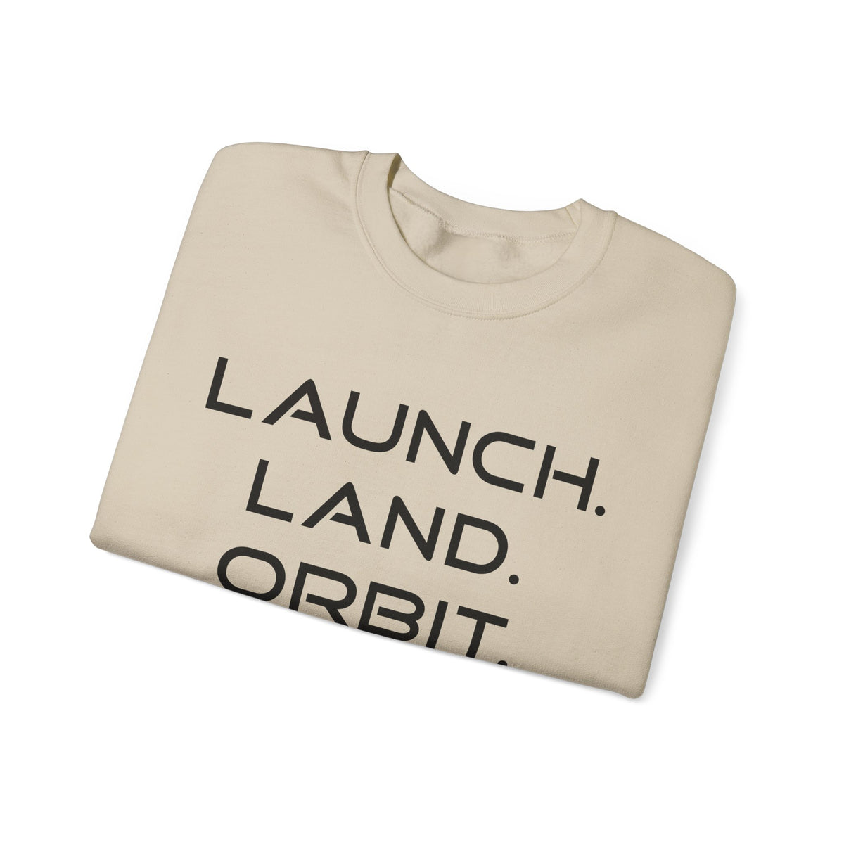 A folded beige crewneck sweatshirt with the words 'LAUNCH. LAND.