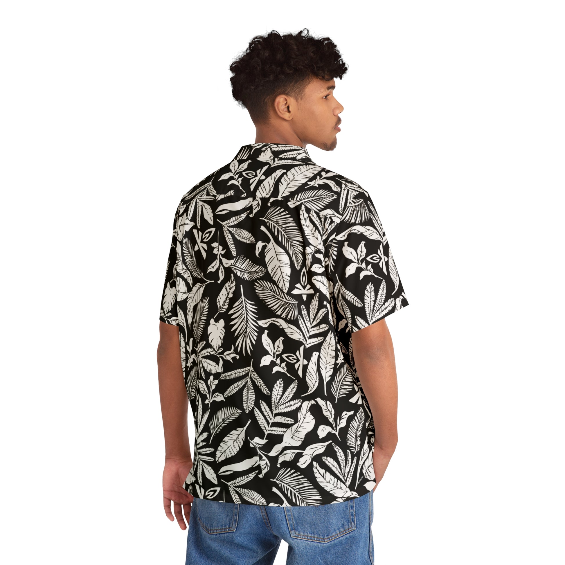 Person wearing a black and white leaf patterned shirt on a white background