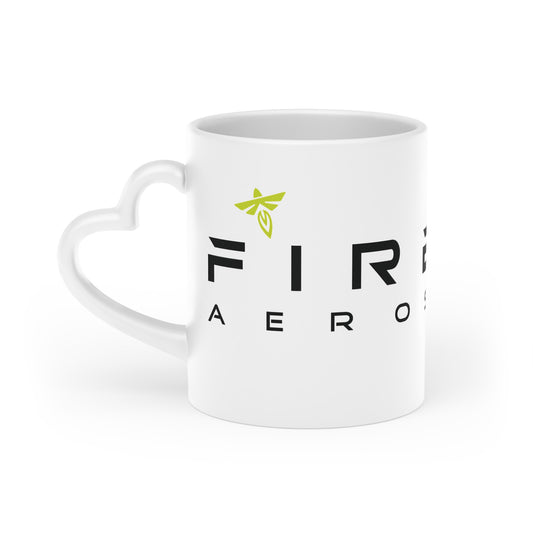 A white ceramic mug with a heart-shaped handle, featuring the black text 'FIRE AERO' and a small lime green winged logo on the front, set against a plain white background.