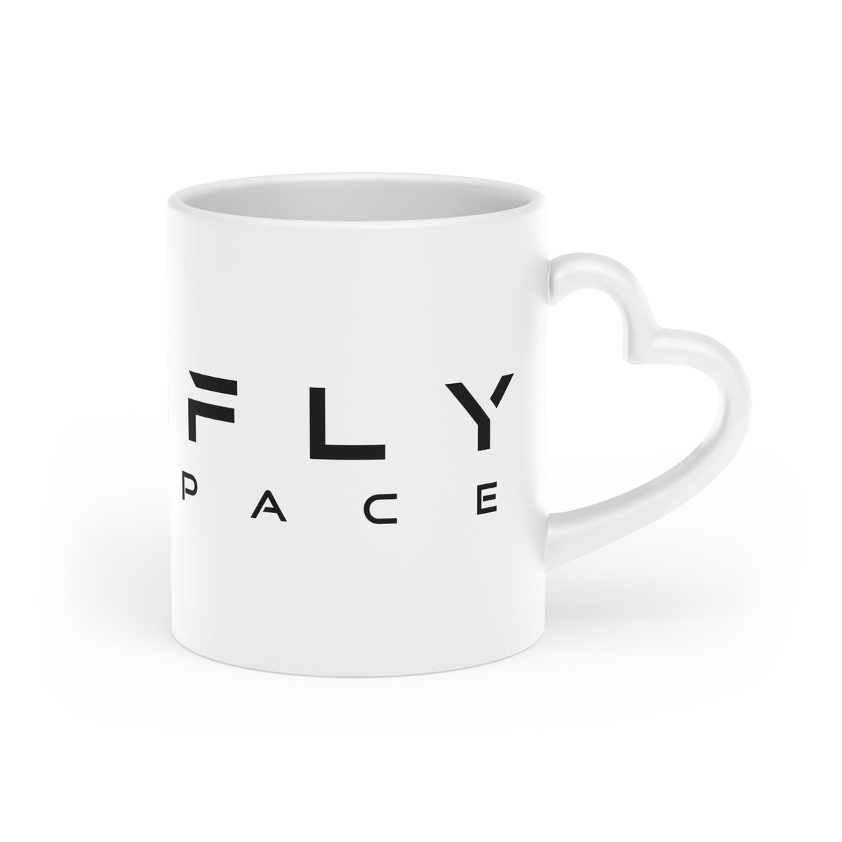 A white ceramic mug with a heart-shaped handle, featuring the black text 'FLY SPACE' printed on the side, set against a plain white background.