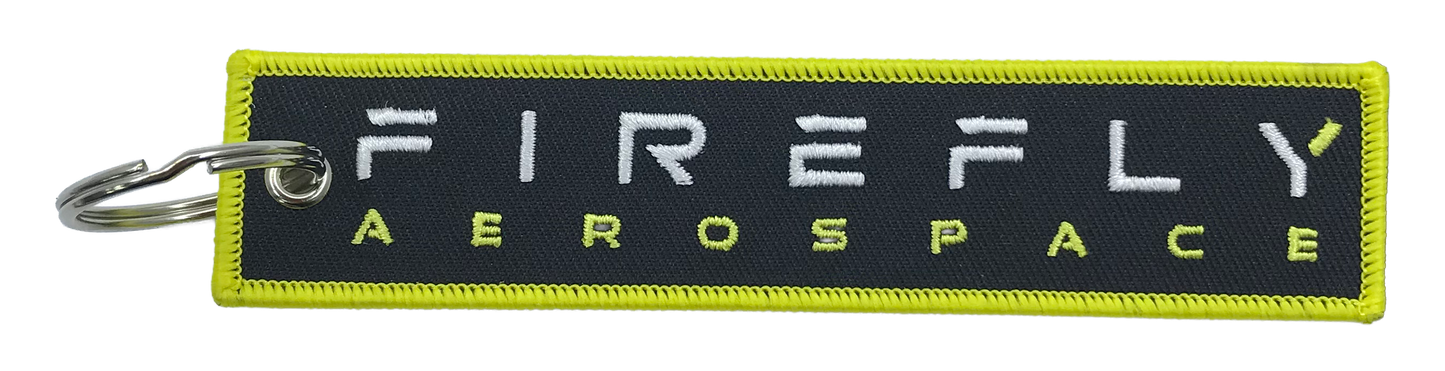 Firefly Aerospace keychain with green border and white text on a black background