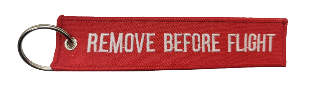 Red keychain with 'REMOVE BEFORE FLIGHT' text on a white background