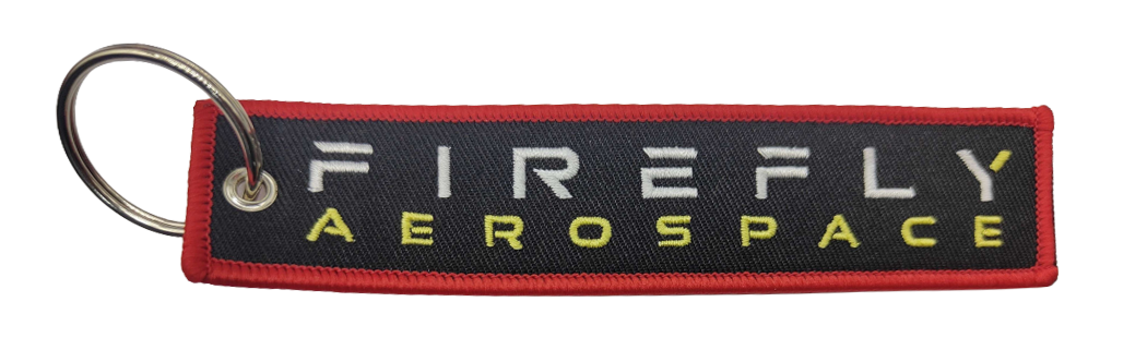 Firefly Aerospace keychain with red border on a white background